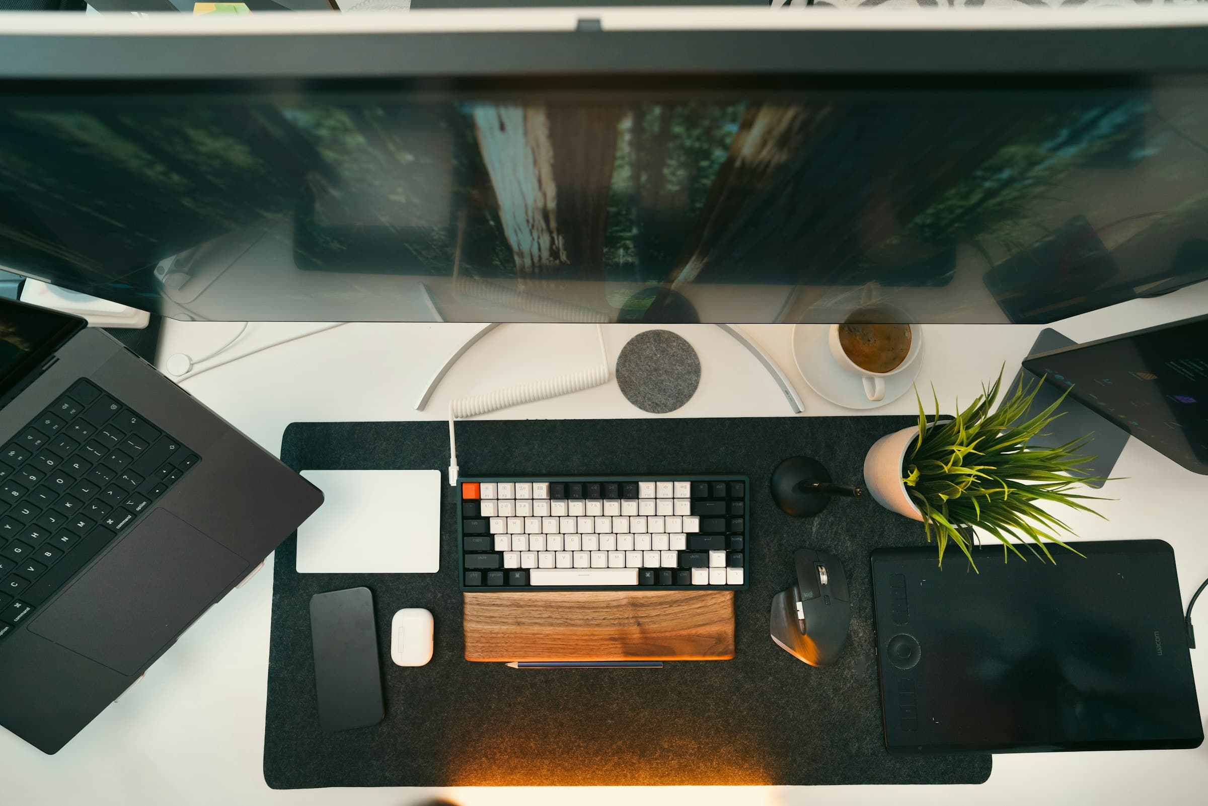 Clean modern developer workspace with a keyboard and dual monitors